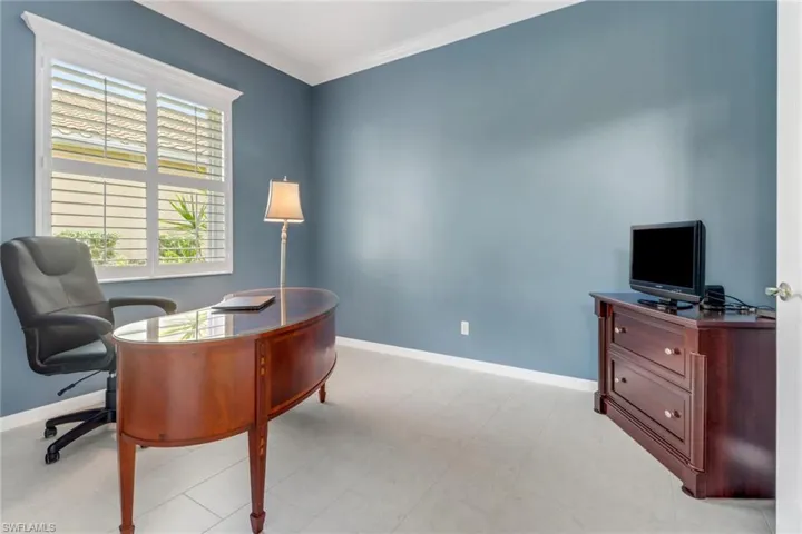Home office with baseboards and crown molding