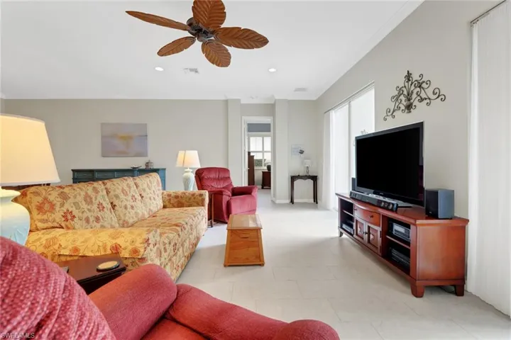 Living room featuring baseboards, ceiling fan, visible vents, and recessed lighting