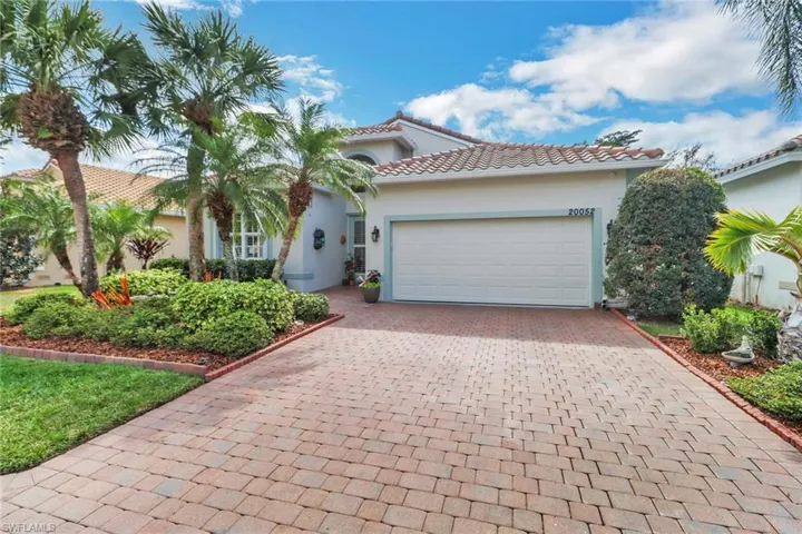 Mediterranean / spanish-style home with stucco siding, an attached garage, decorative driveway, and a tile roof