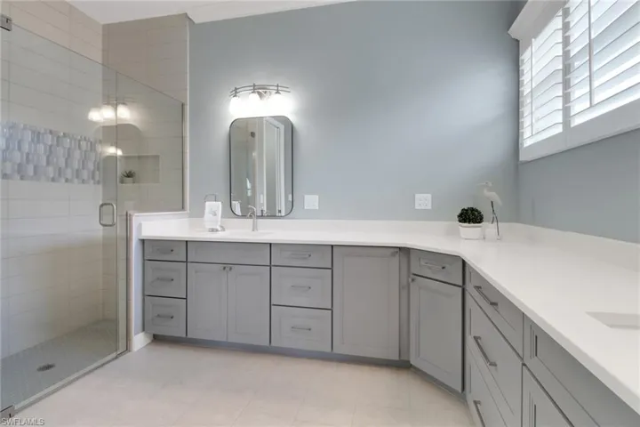 Bathroom featuring vanity and a stall shower