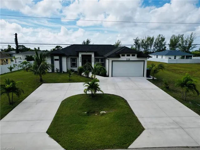 Ranch-style home featuring stucco siding, concrete driveway, a garage, and a shingled roof