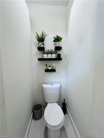 Bathroom featuring toilet and baseboards