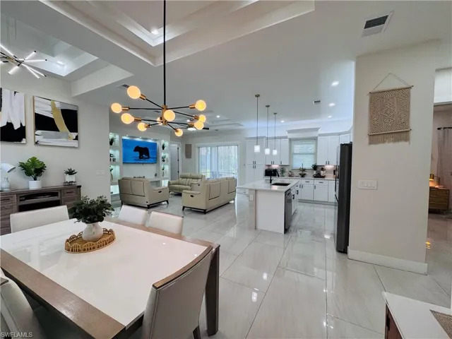 Dining area with a chandelier and recessed lighting