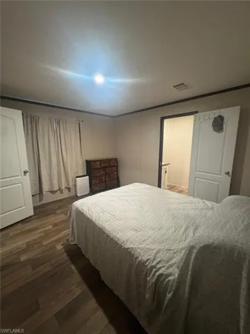 Bedroom with dark wood finished floors