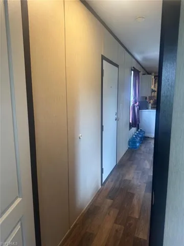 Corridor with dark wood-style flooring