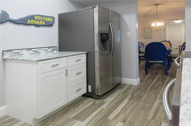 Redone kitchen with refrigerator moved close to the dining room