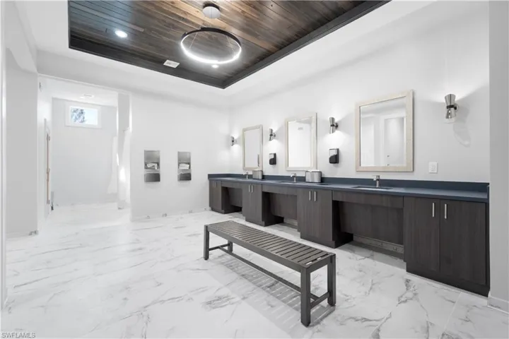 Bathroom with vanity, wooden ceiling, and a tray ceiling
