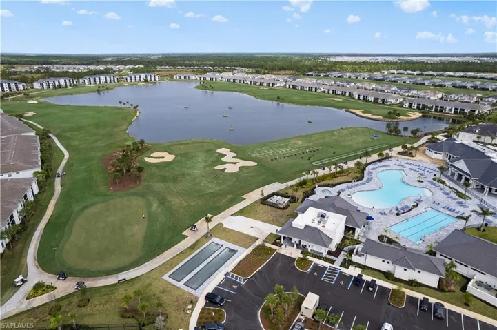 Birds eye view of property with a water view