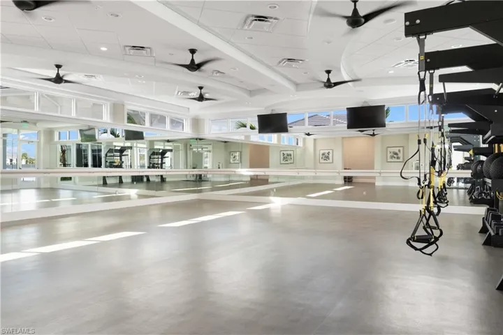 Exercise room with a towering ceiling