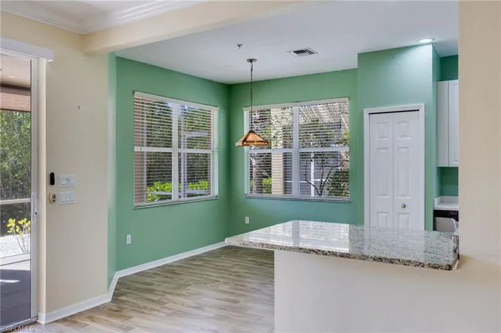 Unfurnished dining area featuring light wood-style floors and baseboards