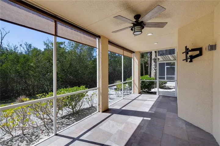 Unfurnished sunroom with a ceiling fan