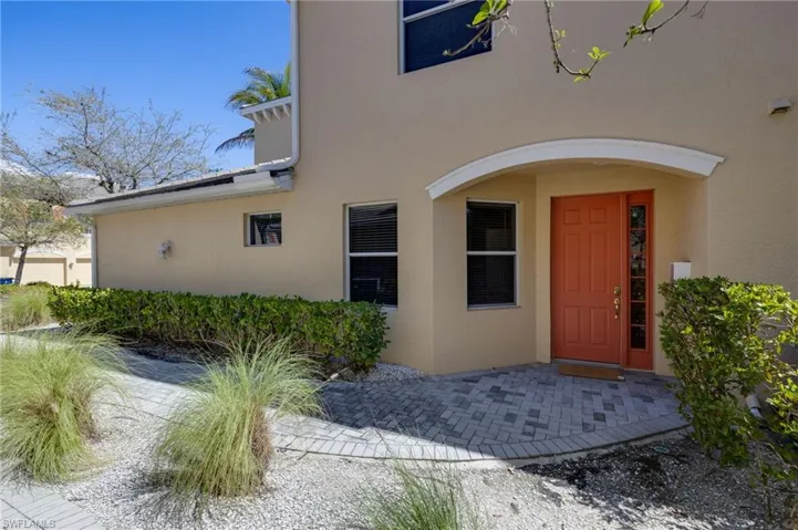 Doorway to property featuring stucco siding