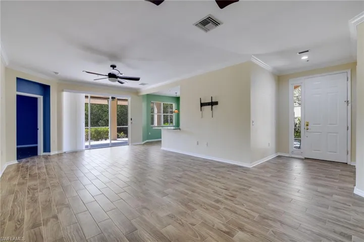 Foyer with wood tiled floors, ceiling fan, and ornamental molding