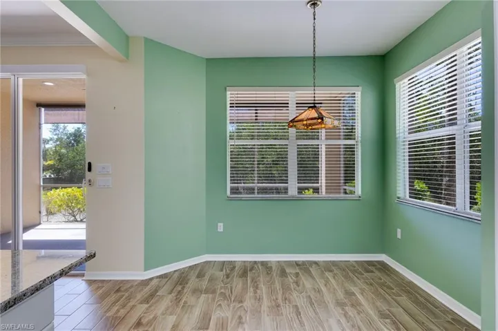 Unfurnished dining area with wood tiled floors