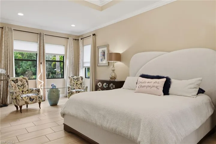 Bedroom with ornamental molding, wood finish floors, and recessed lighting