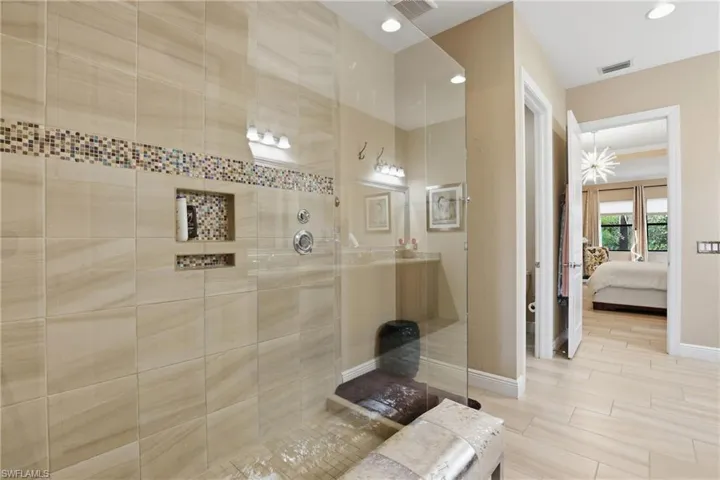 Full bath featuring connected bathroom, a walk in shower, and recessed lighting
