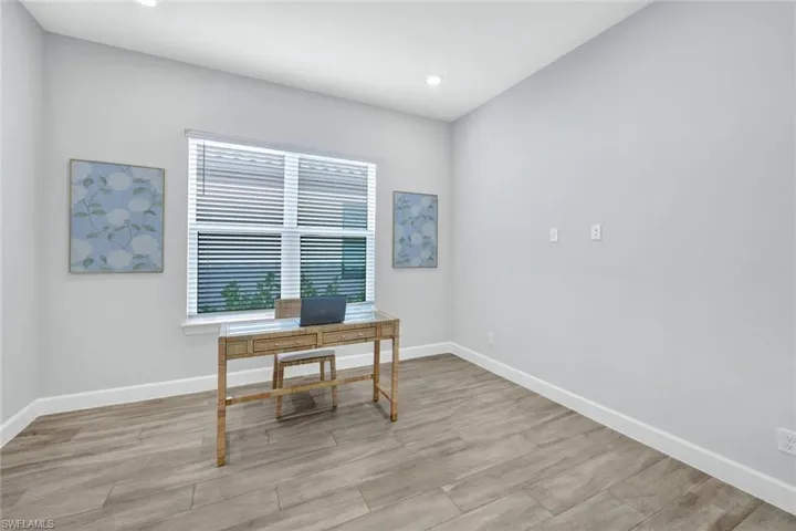 Home office with baseboards, wood finished floors, and recessed lighting