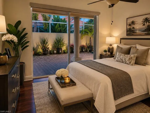 Bedroom featuring wood-finish flooring, a ceiling fan, and direct access to an outdoor paved patio