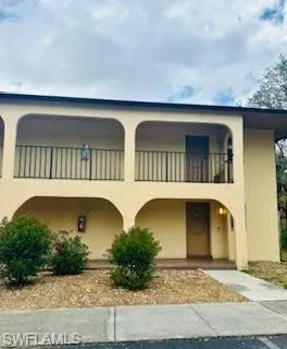View of front facade featuring a balcony and stucco siding