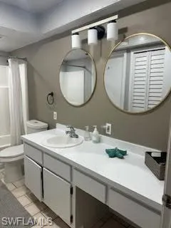 Full bath featuring tile patterned flooring, vanity, and toilet