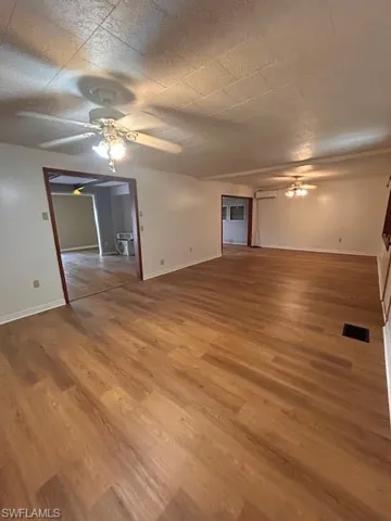 Spare room with ceiling fan and wood-type flooring