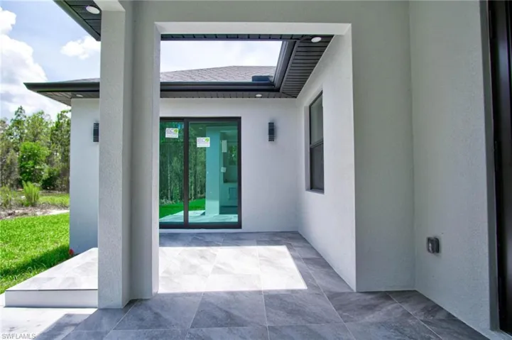 View of exterior entry featuring a patio area