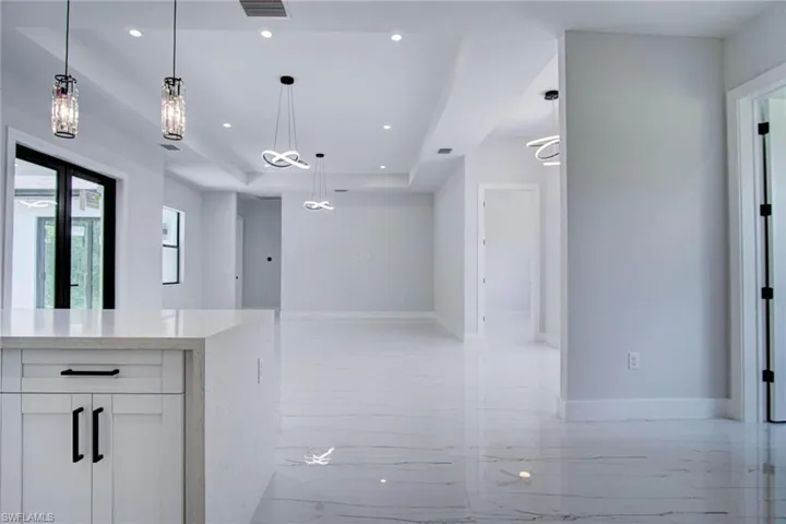 Bathroom with tile patterned flooring, a raised ceiling, and vanity