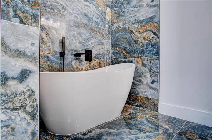 Bathroom with tile patterned flooring and tile walls