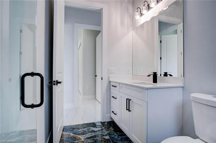 Bathroom featuring tile patterned floors, vanity, and toilet