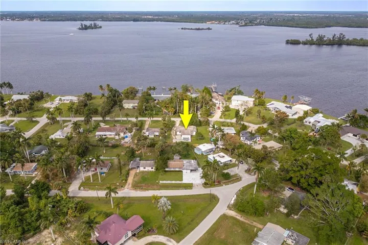 Birds eye view of property with a water view