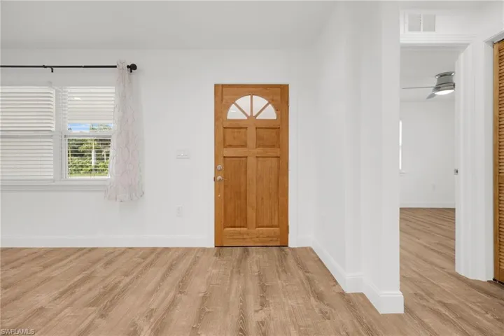 Foyer with light hardwood / wood-style floors