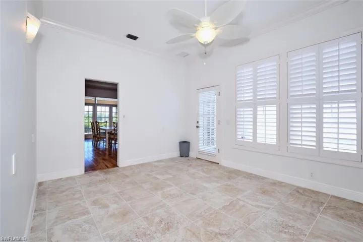 Office with ceiling fan and crown molding
