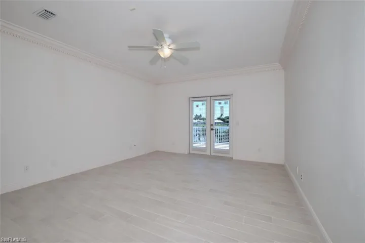 2nd floor bedroom with ceiling fan and ornamental molding
