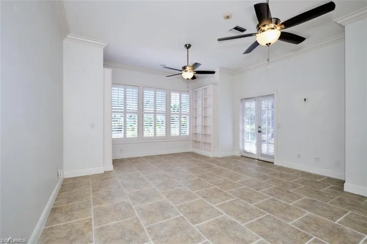 Master bedroom on the 1st floor, featuring plenty of natural light, ceiling fan, ornamental molding, and french doors