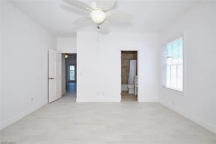 2nd floor bedroom with ceiling fan, ensuite bathroom, and light hardwood / wood-style flooring