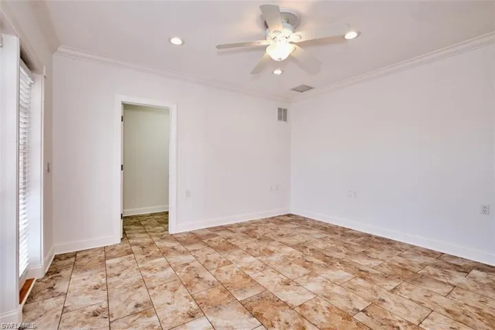 Sunken Bedroom/ Office featuring ceiling fan and crown molding