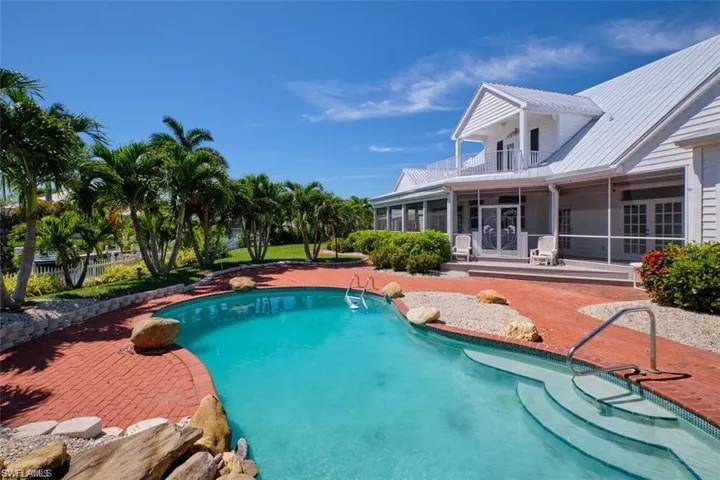 View of swimming pool featuring a patio and a sunroom