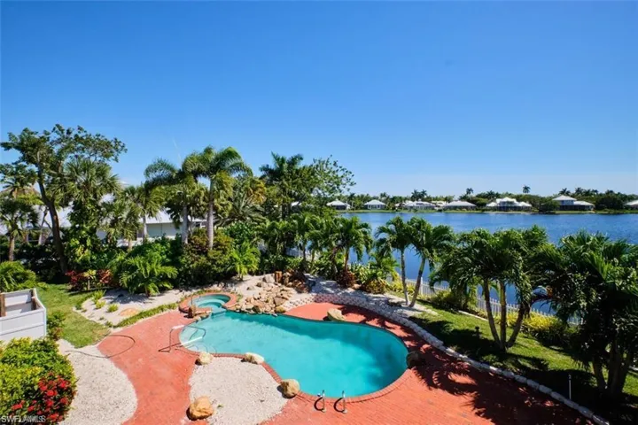View of pool with a patio and a water view