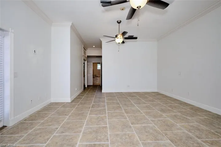 Master bedroom on the 1st floor, featuring ornamental molding and light tile patterned floors