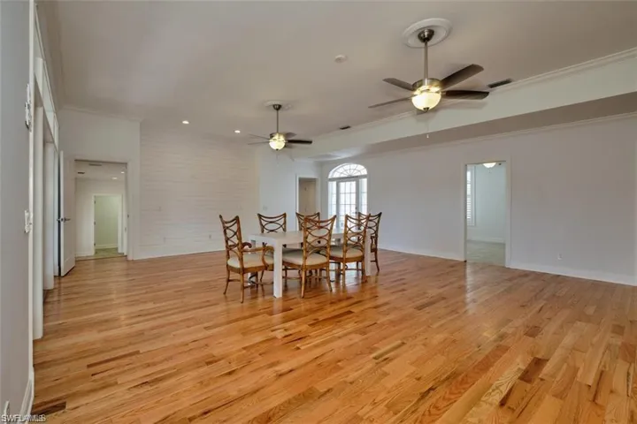 Living room featuring crown molding, light hardwood / wood-style wood flooring, and ceiling fan