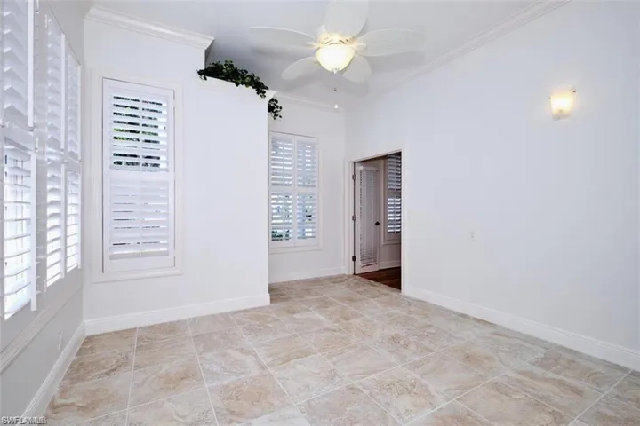 Office with ceiling fan and crown molding