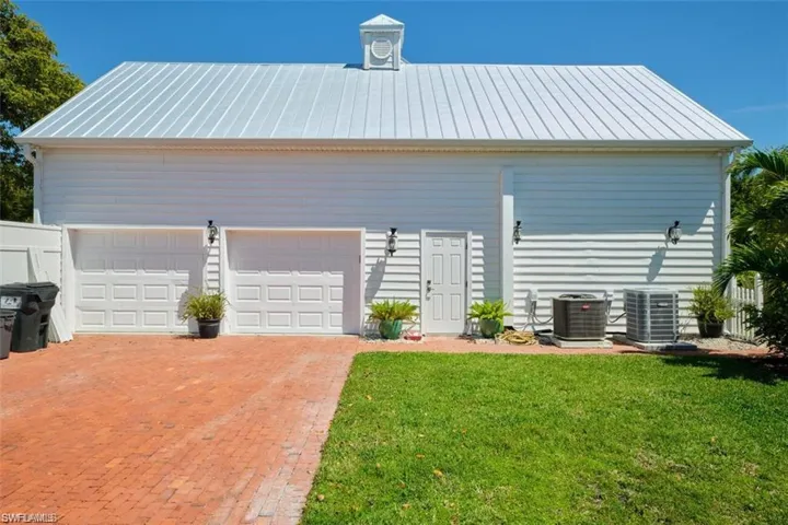 Garage with central AC and a yard