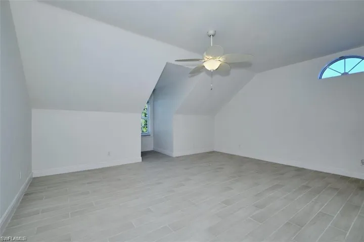 Upstairs Bedroom with vaulted ceiling, plenty of natural light, and ceiling fan