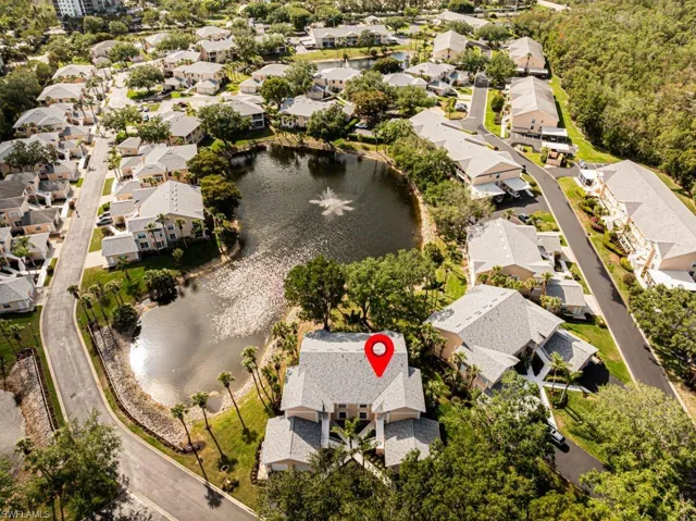 Aerial view of residential area featuring a nearby body of water