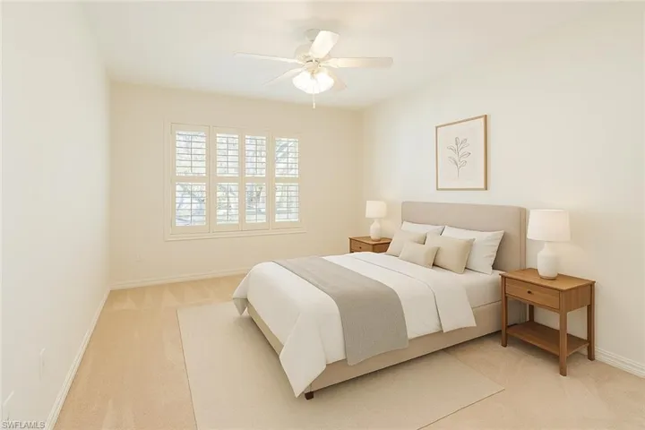 Virtually staged Bedroom featuring light colored carpet and ceiling fan
