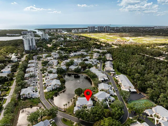 View of property location featuring a large body of water and nearby suburban area