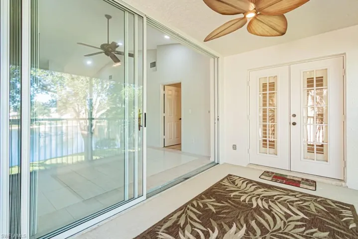 Entrance to property featuring a ceiling fan and french doors