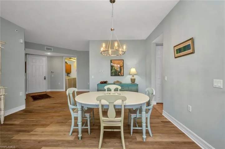Dining area with a chandelier and wood finished floors