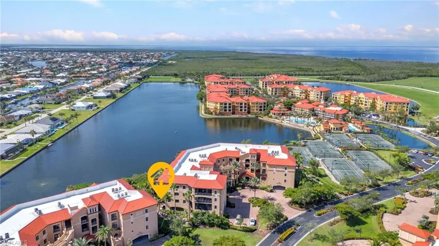 Drone / aerial view of a large body of water and apartment complex