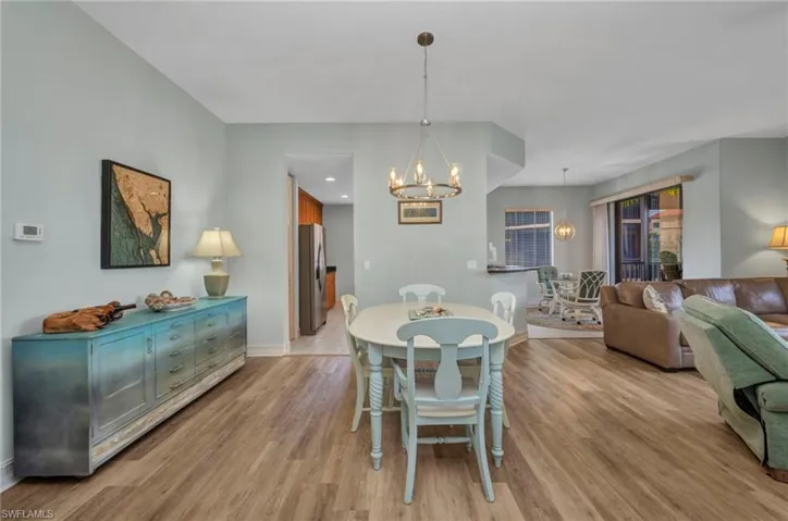 Dining area featuring a chandelier and light wood-style flooring